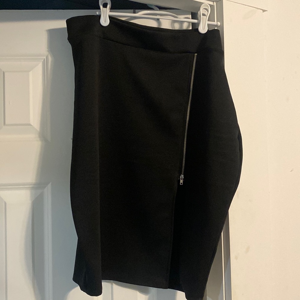Charlotte Russe black knee length skirt with zipper slit. Never worn.